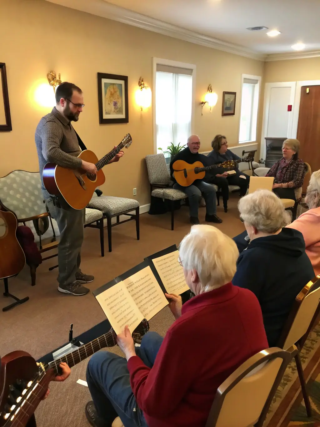 A diverse group of adults learning to play the guitar in a beginner's class, highlighting the inclusive nature of the program.