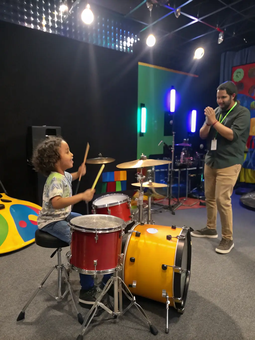 A vibrant photo of children participating in a drumming workshop, showcasing their enthusiasm and engagement with the music.